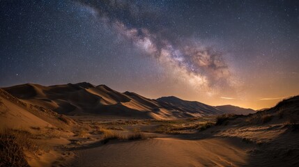Naklejka premium Night Sky Over Desert Landscape with Milky Way and Dunes