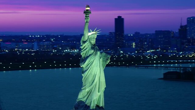 Aerial View of an Iconic Statue of Liberty, New York Harbor at Sunset. Famous Landmark. Symbol of Freedom, Resistance to Oppression, Independence. Orbital Shot from Helicopter.