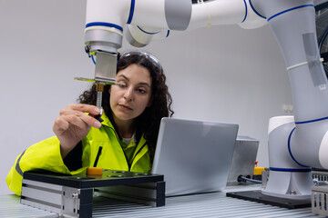 Engineer conducts precision measurement with robotic arm in a modern laboratory setting