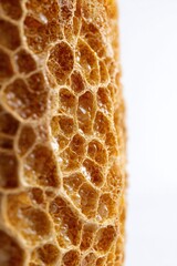 Close-up texture of golden honeycomb showing natural hexagonal pattern