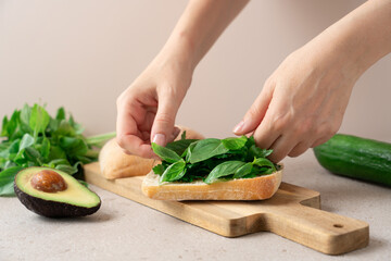 Preparing Fresh Ciabatta Sandwiches with Mozzarella, Avocado, Cucumber, Parsley, and Basil. Healthy...
