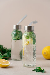 Sparkling Detox Water with Lemon,  Mint and cucumber in Glass Bottles. Refreshing Healthy Beverage