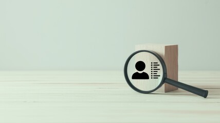Magnifying Glass Focusing on a Human Silhouette and List of Attributes symbolizing recruitment and job search