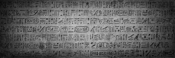 Old Egyptian hieroglyphs on an ancient background. Wide historical background. Ancient Egyptian hieroglyphs as a symbol of the history of the Earth.