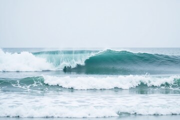 Fototapeta premium An ocean wave crashes with vibrant aqua water, rising powerfully against the backdrop of a moody gray sky