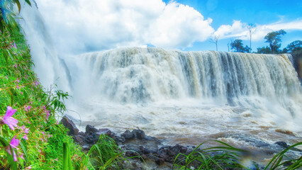 Fototapeta premium Spectacular view of the waterfall during a clear sky. The impressive wide waterfall.