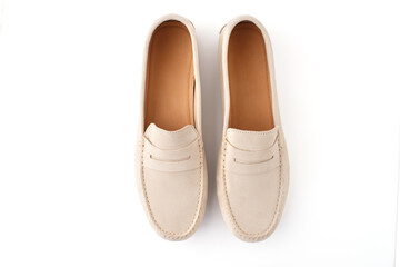 Pair of beige suede penny loafers isolated on white background. Studio product photo. Casual footwear concept. Design for banner, poster, card, header. Flat lay composition with copy space 