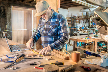 carpenter at work measuring pieces of art wood