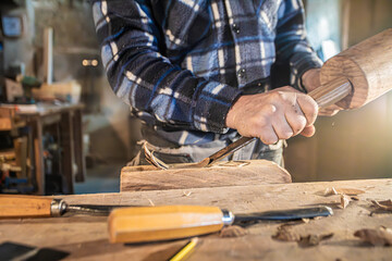 carpenter carved piece of wood in workshop