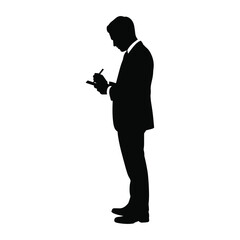 Silhouette of a businessman in a suit writing on a notepad