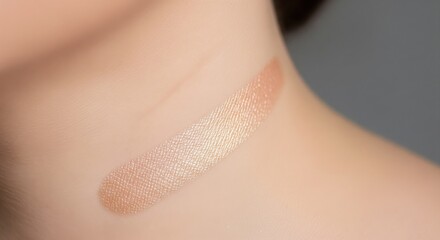 Close-up of Shimmering Peach Gold Highlighter Swatch on Skin