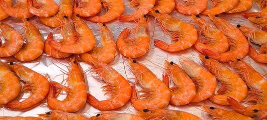 Orange boiled shrimp on a silver tray in a restaurant