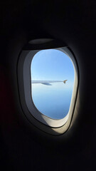 Malaga, Spain - July 02, 2025: Airplane window view showcasing clear blue sky and wing over Malaga Airport landscape with copy space for text