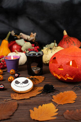 Festive Halloween table decor with pumpkins, candles, and seasonal treats