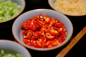 a bowl of sliced red chili peppers
