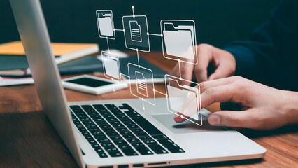 Person using laptop with file management icons overlaid on the keyboard area