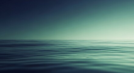 Obraz premium Serene ocean horizon with gentle waves reflecting a soft, diffused light under a vast, gradient sky.