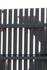 This image features a close up view of a fence set against a plain white background, highlighting its details and design effectively