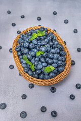Wooden basket with blueberries and dried flowers, creating a perfect composition for product photography or decoration