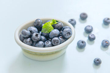 Various-sized glasses filled with blueberries, forming a geometric and visually balanced composition