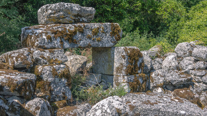 The ruins of the city of Termessos are located in Turkey high in the mountains. The remaining fragments of buildings in the ancient city are made of large smooth stone blocks.