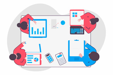 Diverse team collaborating around a table with data charts and technology devices