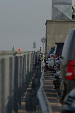 A row of cars is neatly parked along the side of the road, creating an organized appearance that showcases their various colors and models