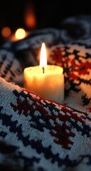Warm candlelight on a cozy, patterned blanket
