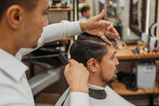 Mature man getting haircut at barbershop