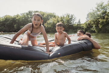Cheerful family swimming in river