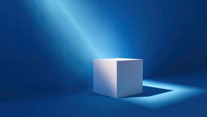Fototapeta premium White cube illuminated by spotlight on dark blue backdrop