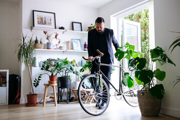 Businessman entering with bicycle at home