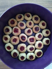 Homemade Thumbprint Cookies with Raspberry Jam in a Purple Tin