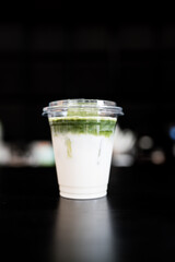 Iced matcha latte with layers of green and fresh milk, a refreshing drink