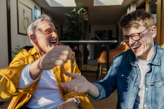 Father and son celebrating new home ownership indoors