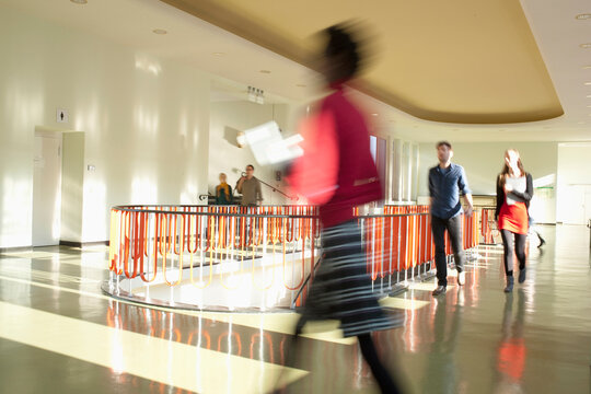 Germany, Leipzig, University students walking through corridor (blurred motion)