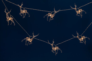 Garland with glowing deer figures. Holiday decoration during Christmas or New Year