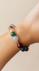 Bracelet in Hand: A colorful bead bracelet adorns a wrist, showcasing its elegant design and vibrant tones