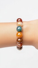 Gemstone Bracelet on Wrist: An elegant gemstone bracelet adorns a wrist, showcasing the natural beauty and rich colors of various polished stones.