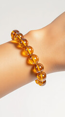 Elegant amber bracelet on wrist: A close-up shot of an elegant amber bracelet gracefully adorns the wrist.