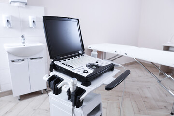 Modern ultrasound machine and examination bed in clinic