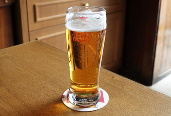 Glass of beer on a table in a pub, close-up
