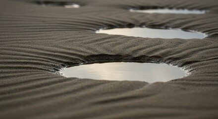 Rippled sand, tranquil puddles