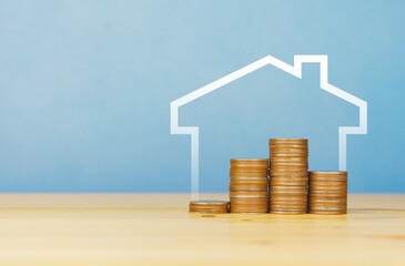rising stacked coins with house. copy space
