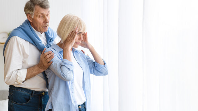 Family disagreement. Man consoling senior woman after argument, offended wife
