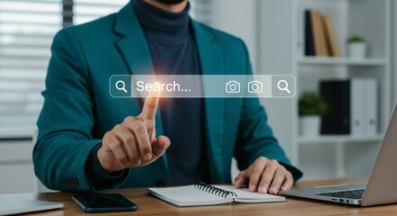 Finger pressing a search bar on a digital interface, illuminated by an orange glow, suggests information retrieval or navigation.