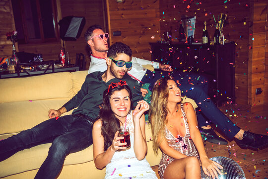 Carefree male and female friends enjoying in party
