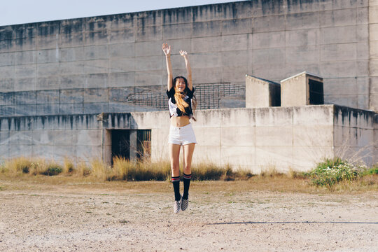 Spain, teenage girl jumping outdoors