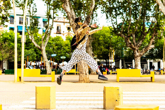 Girl jumping from bollard to bollard