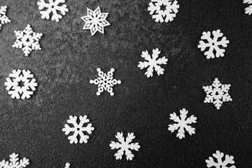 Snowflake pattern on black textured background for winter, holiday or seasonal decoration concept